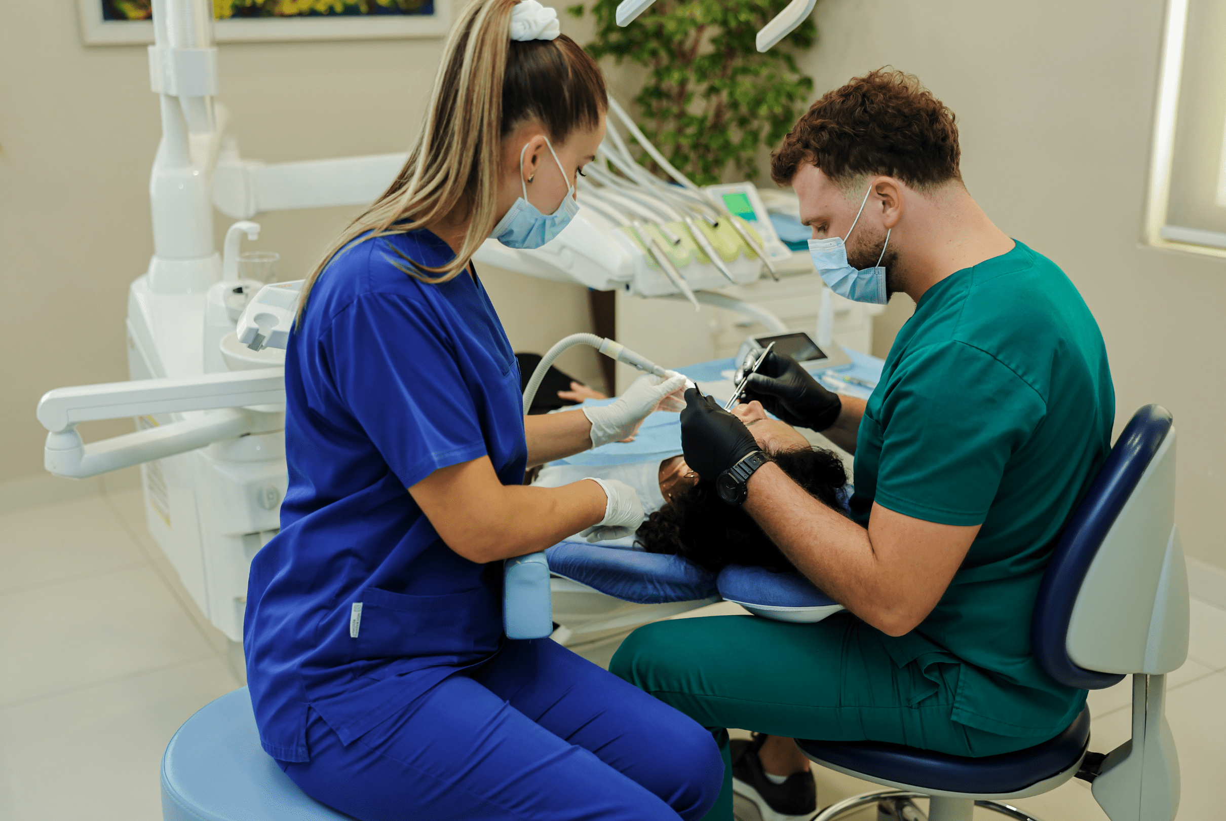 Dental assistant helping Dr. Ronaldo Bode during treatment