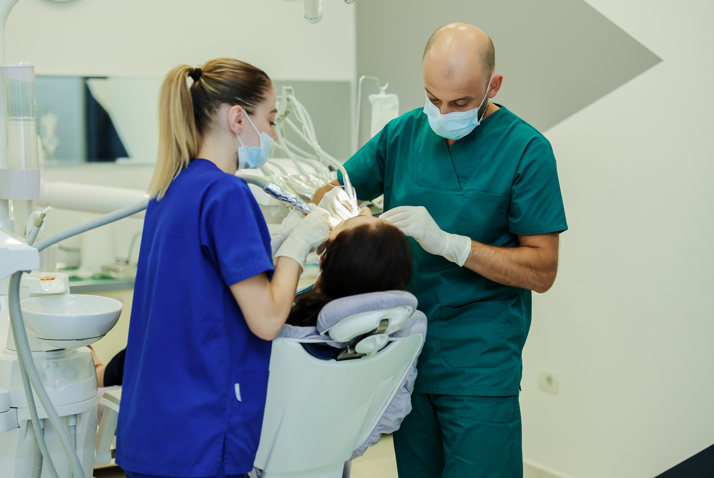 Dental assistant helping Dr. Besmir Metalla during treatment